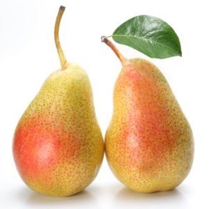 Two appetizing pears with a leaf. Isolated on a white background.